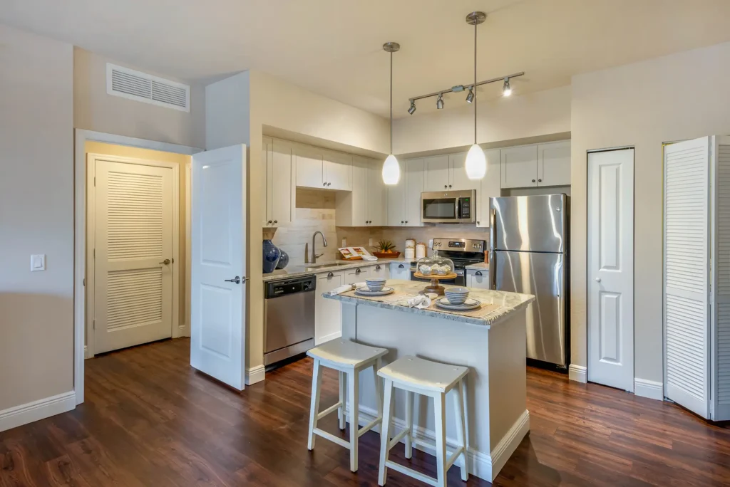 Kitchen with stainless steel appliances, granite countertops, and backsplash.