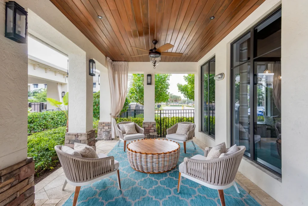 Outdoor covered plush seating space with fan