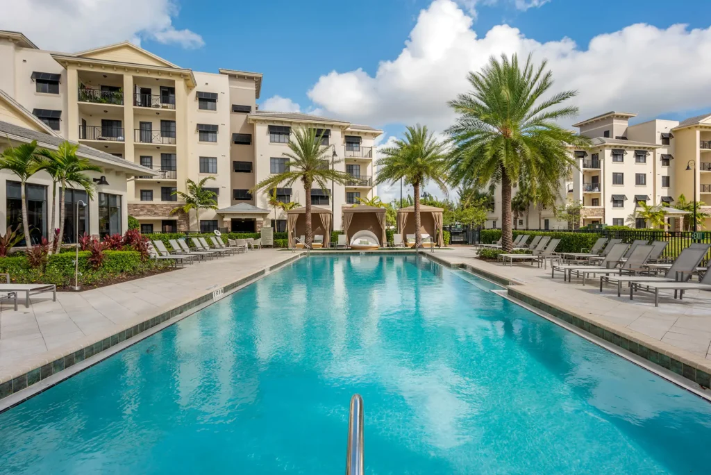 Pool with deck seating and covered cabanas.