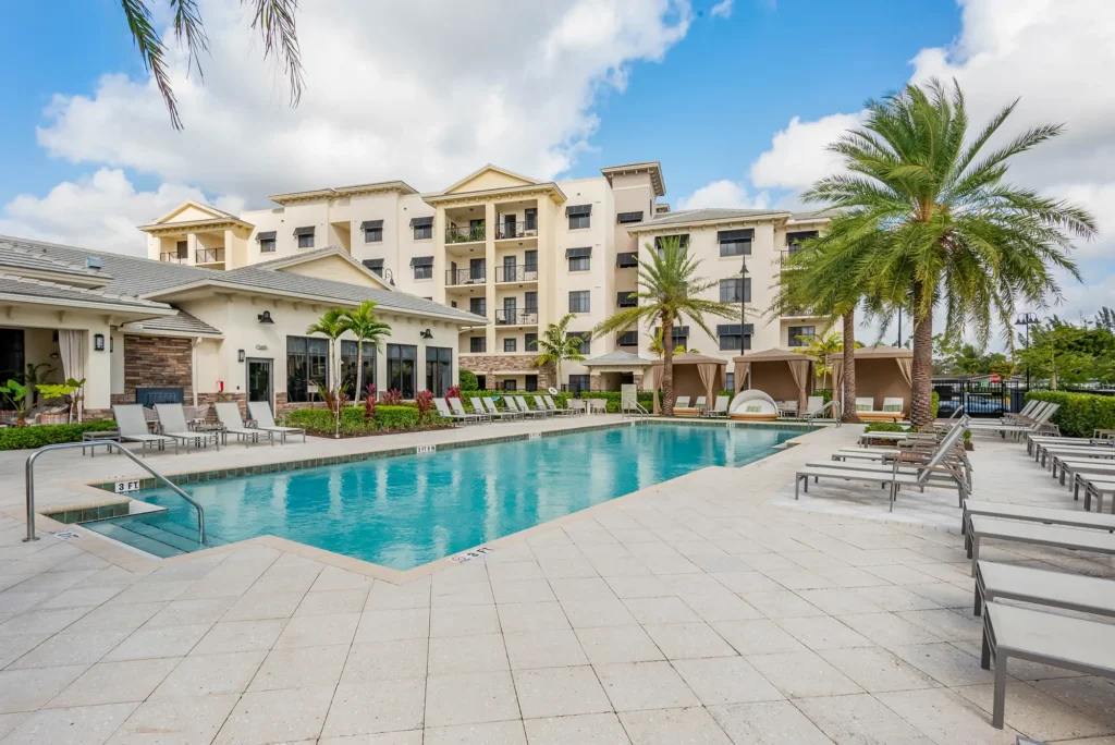 Pool with deck seating and covered cabanas.
